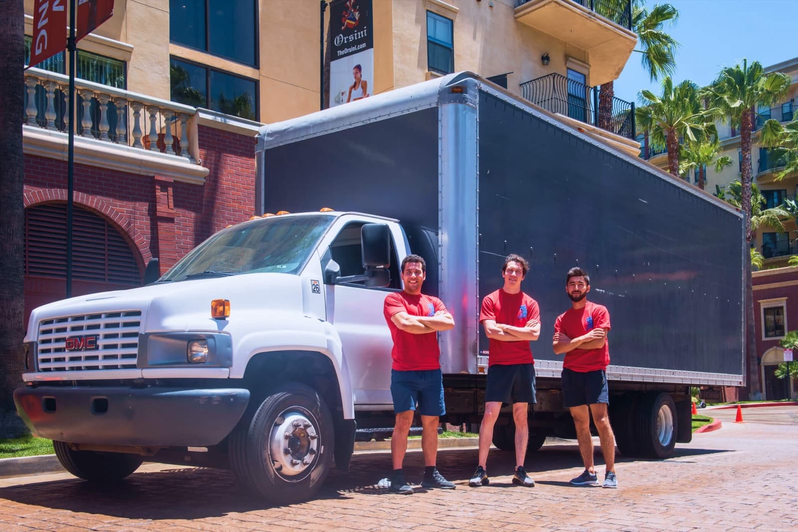 Three-man crew with the box truck outside an apartment building in Los Angeles