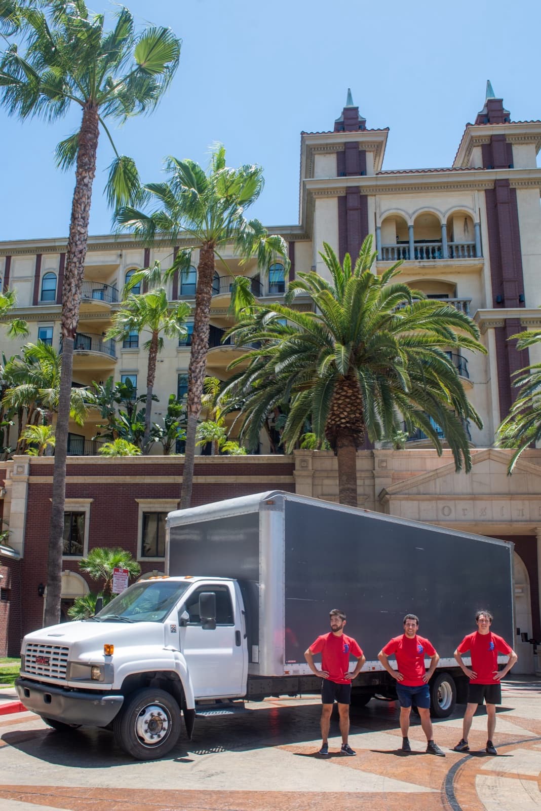 The crew and the truck in front of a client's building