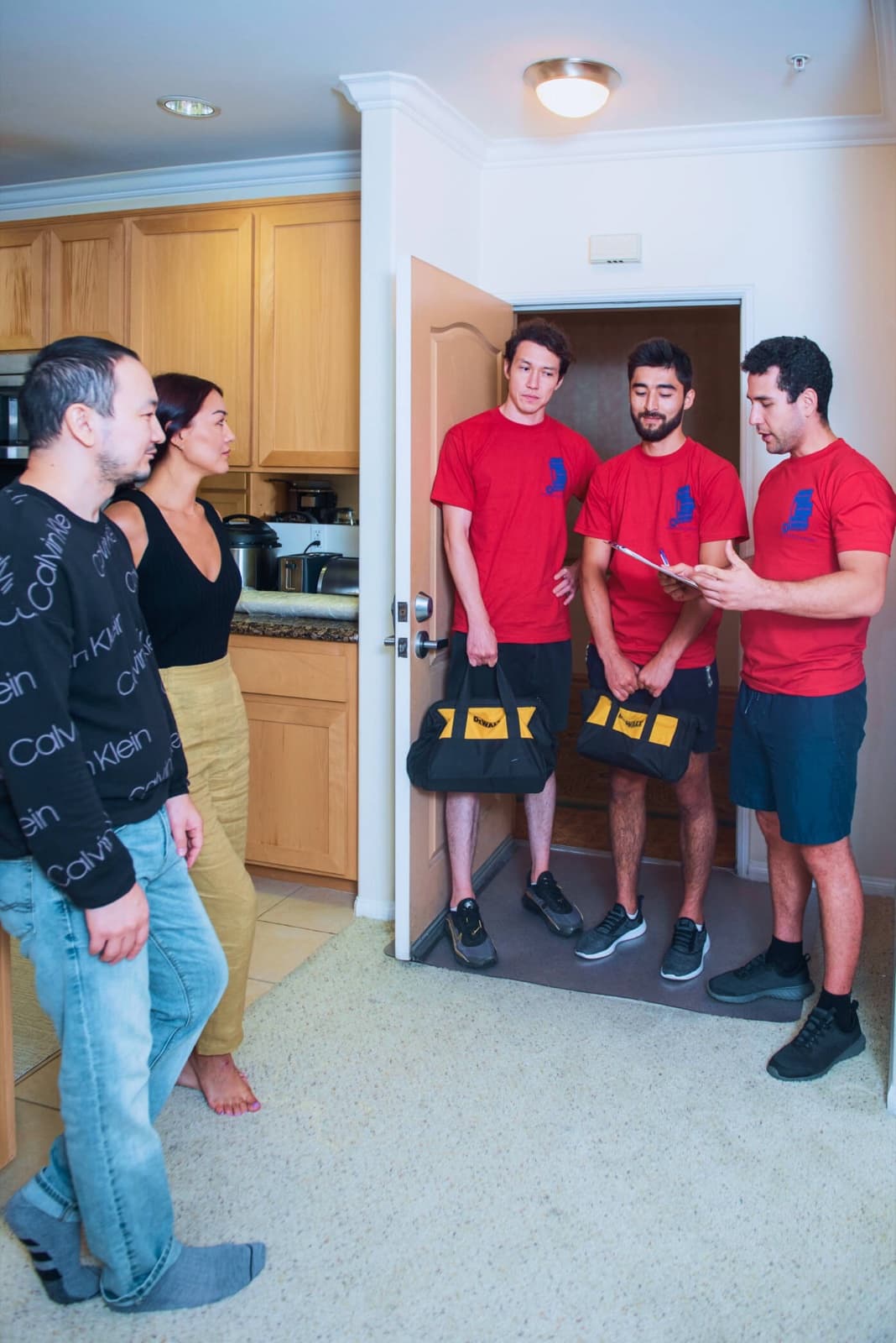 Crew walkthrough with clients at the front door